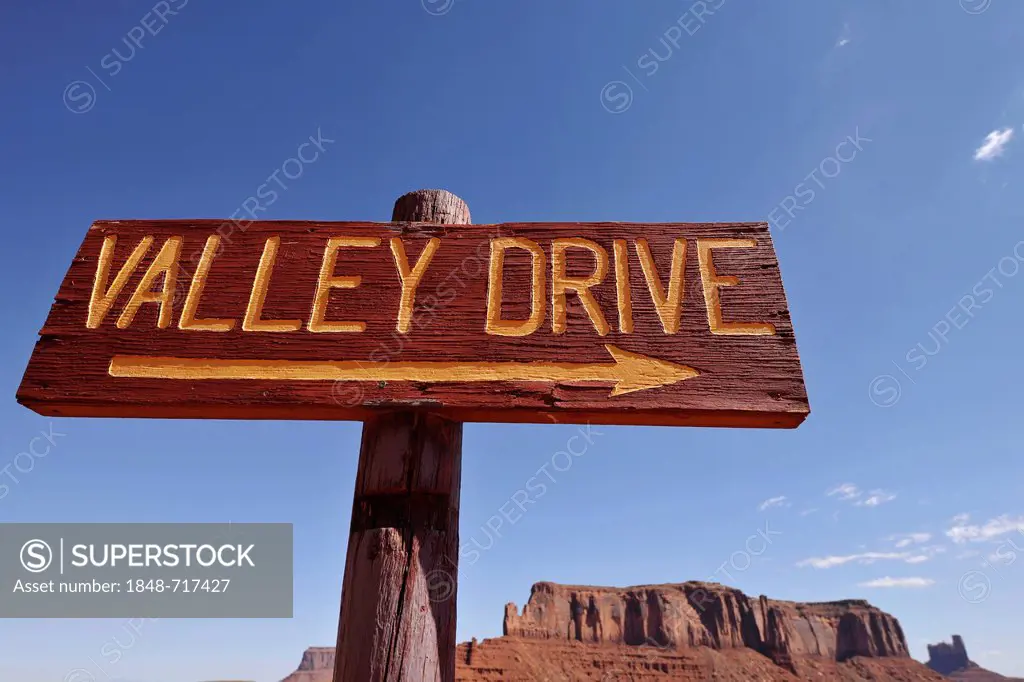 Sign Valley Drive in front of Sentinel Mesa and Castle Butte table mountains, Monument Valley, Navajo Tribal Park, Navajo Nation Reservation, Arizona,...