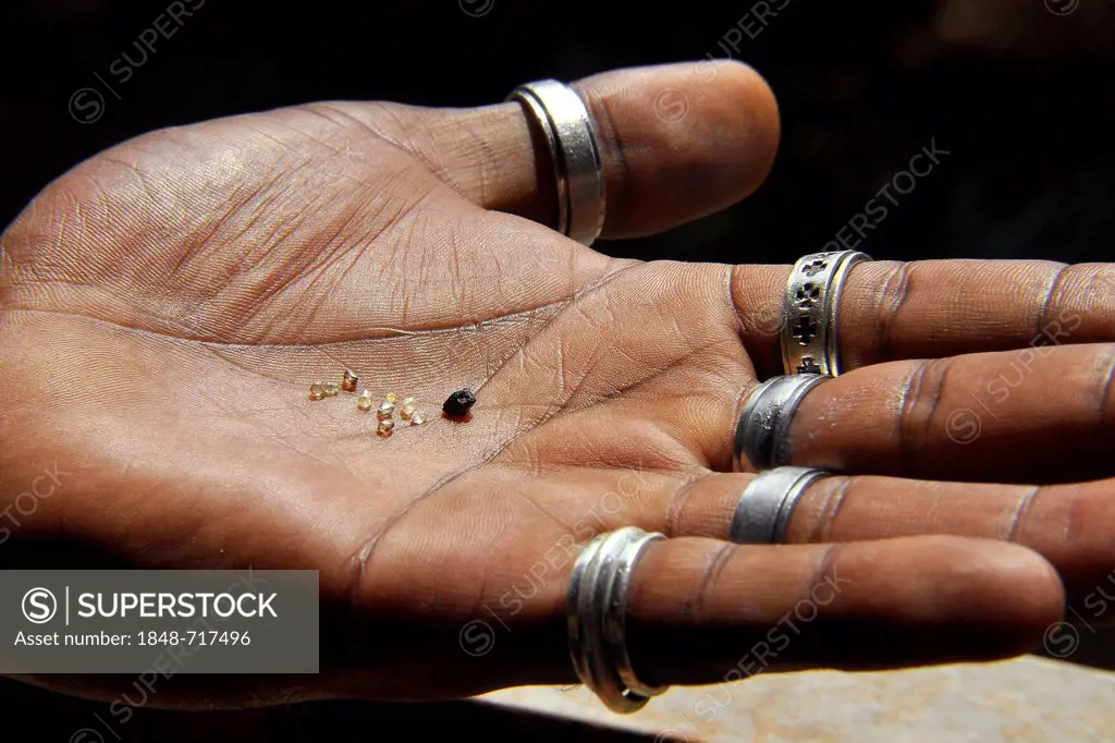 Hand holding rough diamonds, Chapada Diamantina, Bahia, Brazil, South America