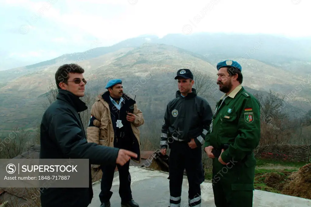 Indian, German and Kosovan police officers and a translator, international police patrol, the police operations are part of the United Nations Mission...