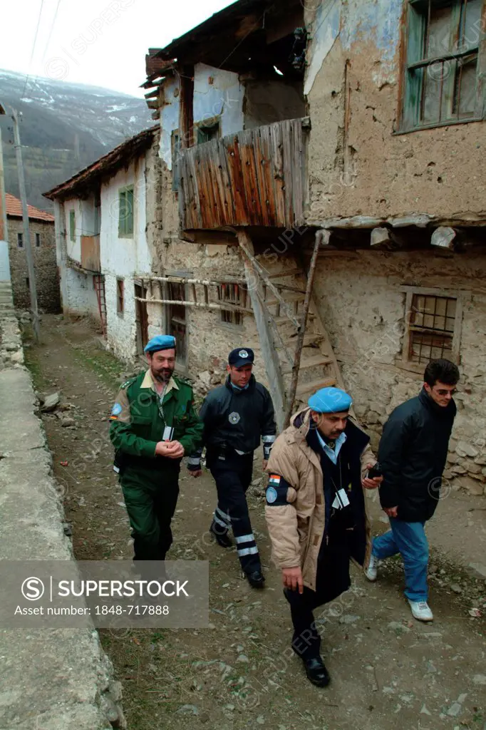 Indian, German and Kosovan police officers and a translator, international police patrol, the police operations are part of the United Nations Mission...