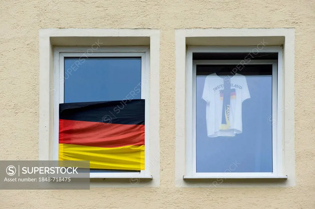 Window of a soccer fan with a German flag and a jersey of the German team