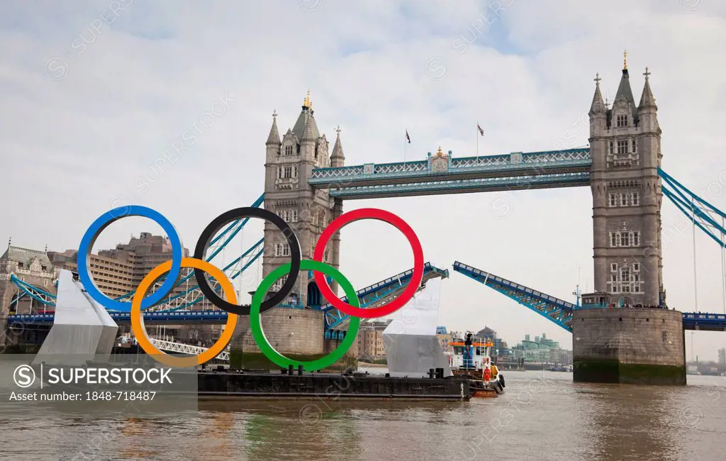 Giant Olympic Rings are floated down the River Thames and passing open Tower Bridge to promote the Olympic Games in London 2012, London, England, Unit...