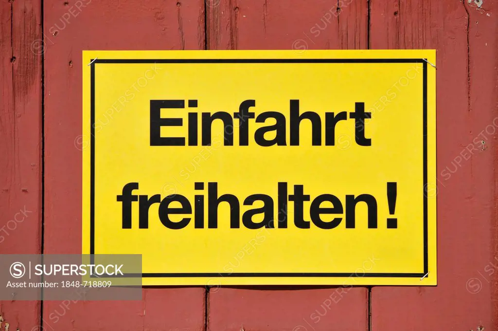 Sign, Einfahrt freihalten! German for Keep entrance clear, yellow on a red wooden gate, Germany, Europe