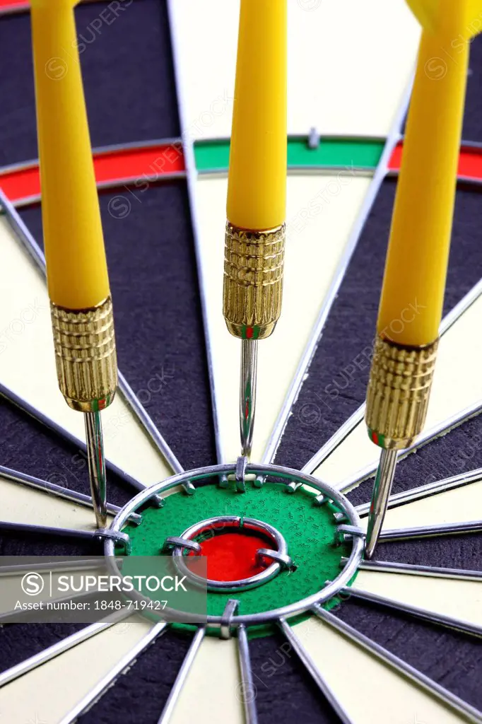 Darts, throwing game, darts narrowly off the middle of the dartboard, the bullseye