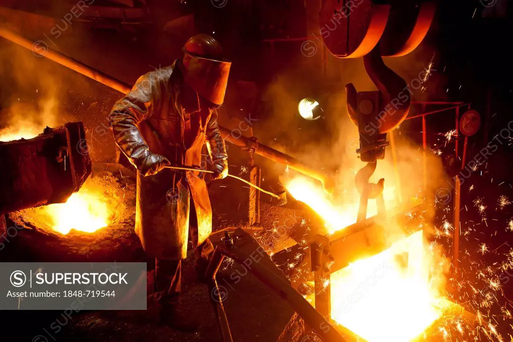 Smelter worker wearing protective equipment, employee of the Luitpoldhuette AG, a foundry that specializes in the casting of engine blocks, motor part...