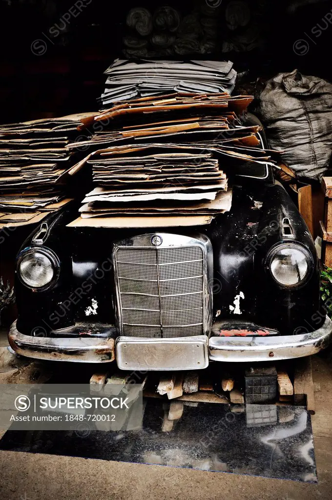 Old vintage Mercedes covered with cardboard in Yangon, Myanmar, Burma, Southeast Asia, Asia