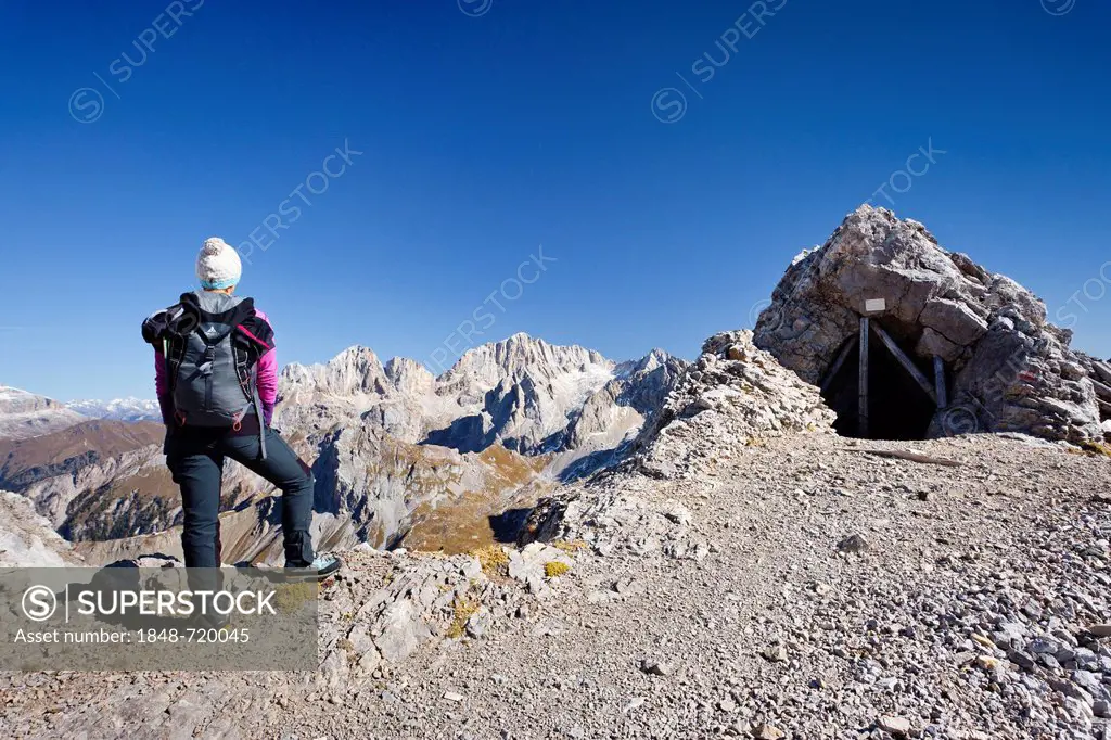 Hiker on Costabela Mountain while using the Bepi Zac climbing route in San Pellegrino Valley above San Pellegrino Pass, overlooking Marmolada Mountain...