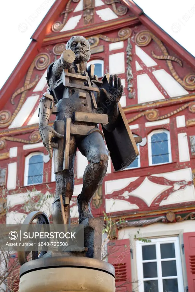 Statue of Goetz von Berlichingen by Gunther Stilling in front of the ornate half-timbered building of the Old Town Hall, Jagsthausen an der Jagst, Hoh...