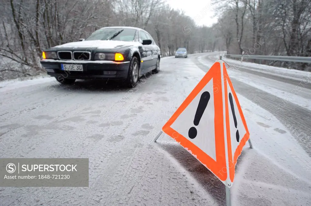 Warning triangle on a slippery snow-covered road in front of a 7 Series BMW E38 series vehicle, Stuttgart, Baden-Wuerttemberg, Germany, Europe
