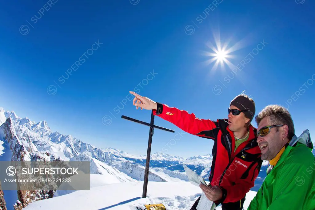 Two mountaineers on the summit of Mt Torrenthorn, Leukerbad, Valais, Switzerland, Europe