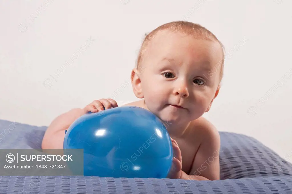 Baby boy, 8 months, with a balloon