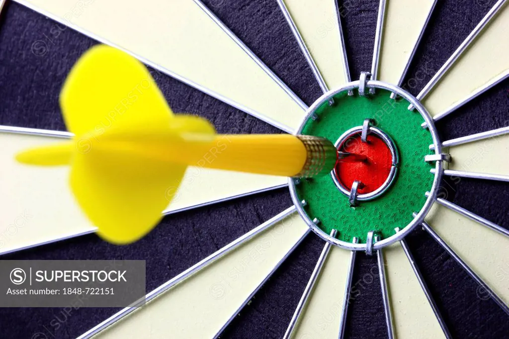 Darts, throwing game, dart sticking into the middle of the dartboard, the bullseye