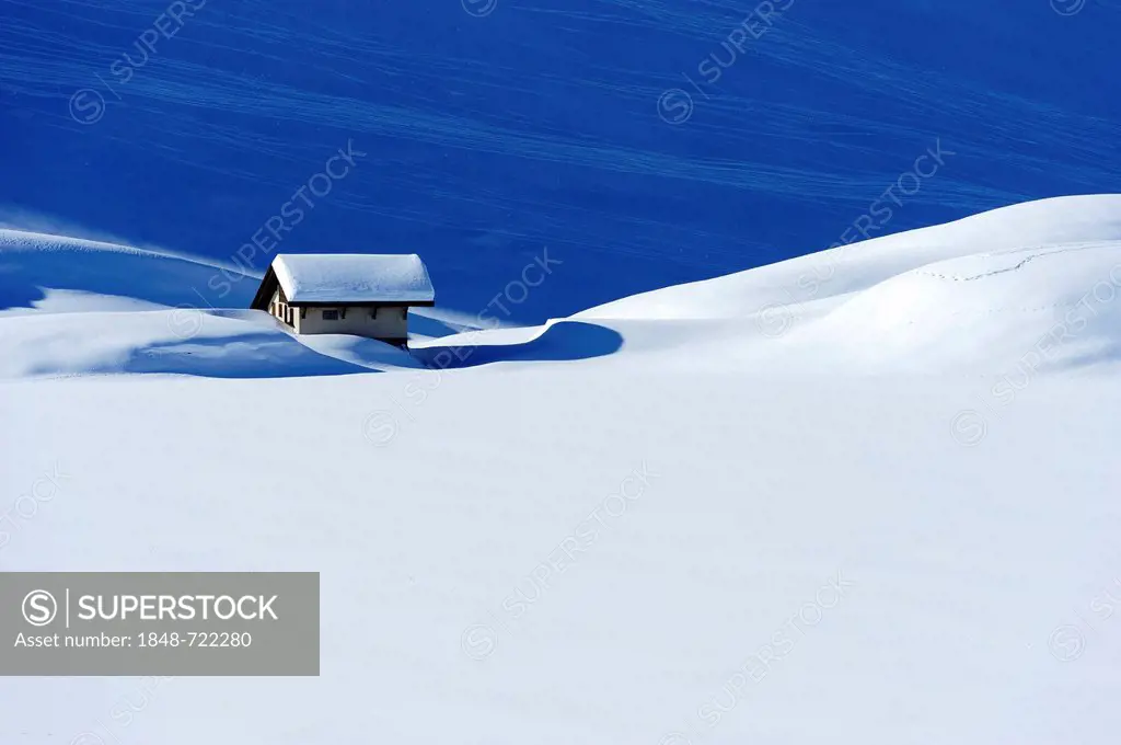 Snow-covered mountain chalet at Lake Truebsee near Engelberg Mountain, Obwalden, Switzerland, Europe