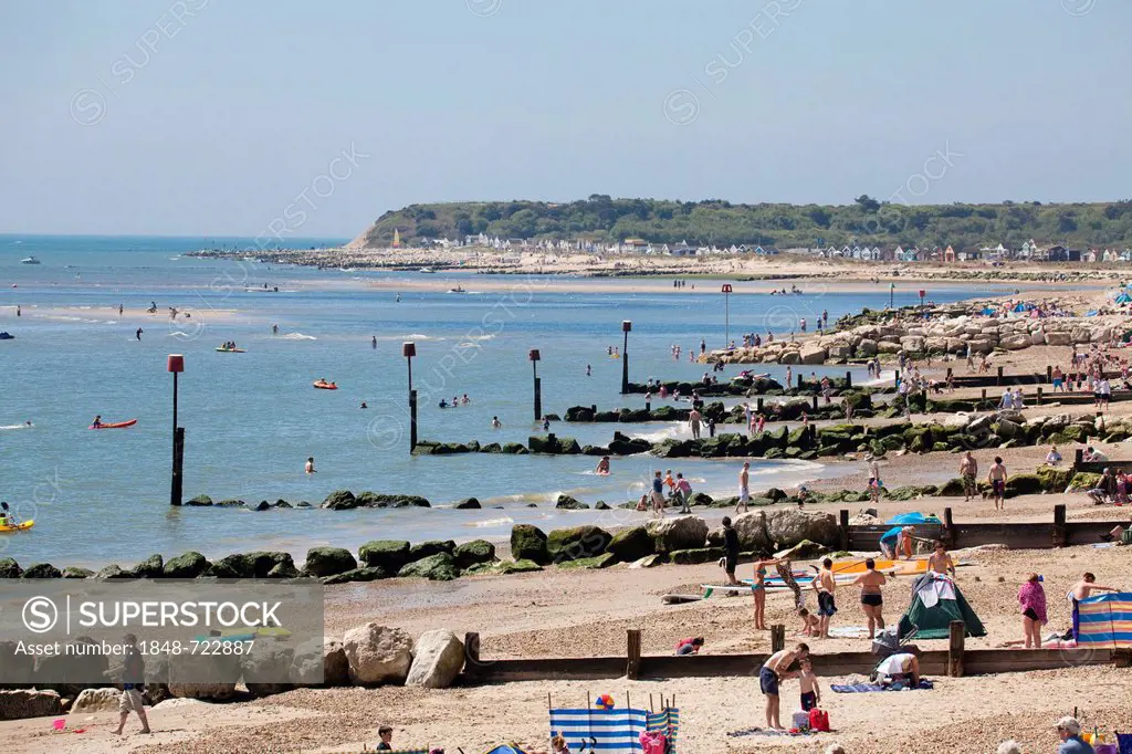 Rows of wooden and rock groynes, sea defences, with red marker poles on Mudeford beach, Mudeford, Dorset, England, United Kingdom, Europe