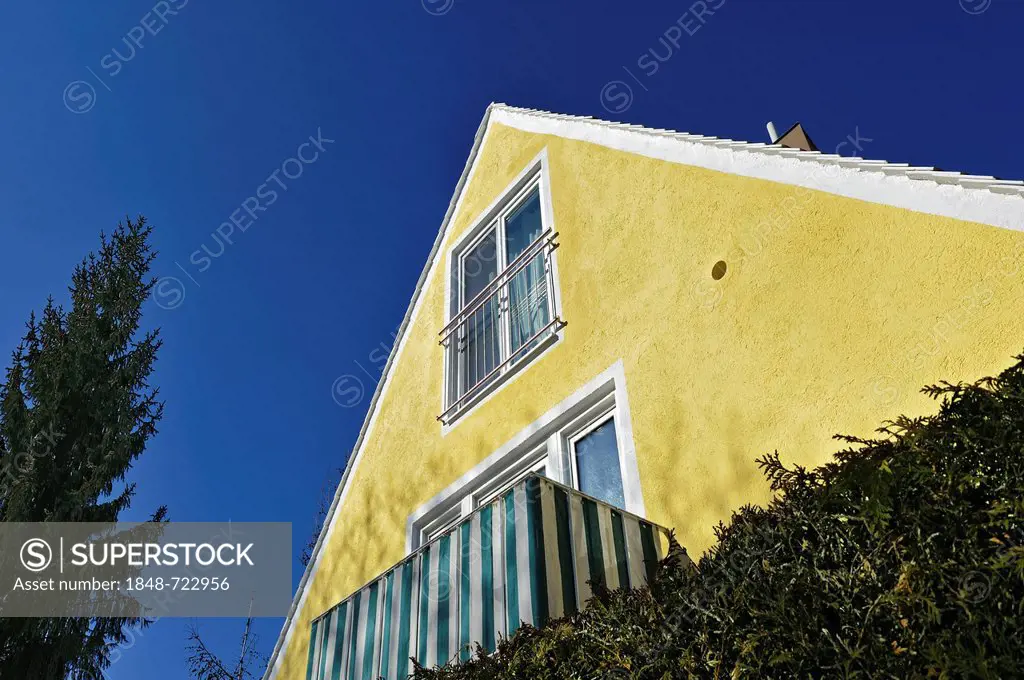 Gable of a yellow house with a balcony, Munich, Bavaria, Germany, Europe