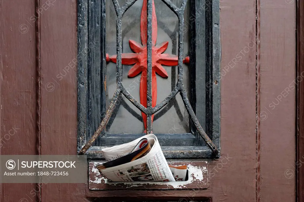 Entrance door to an old apartment building, newspaper sticking in the mail slot, Bruckhausen quarter, Duisburg, North Rhine-Westphalia, Germany, Europ...