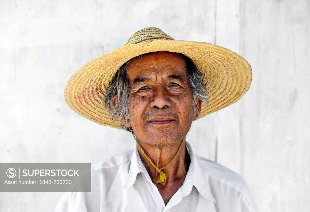 Portrait of an elderly man wearing a straw hat at Inle Lake in Myanmar, Burma, Southeast Asia, Asia