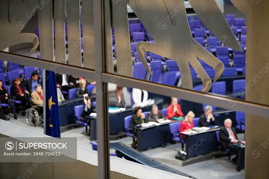 Parliamentary session in the Plenary Assembly Hall of the Reichstag building, part of the German federal eagle is in the foreground, Berlin, Germany, ...