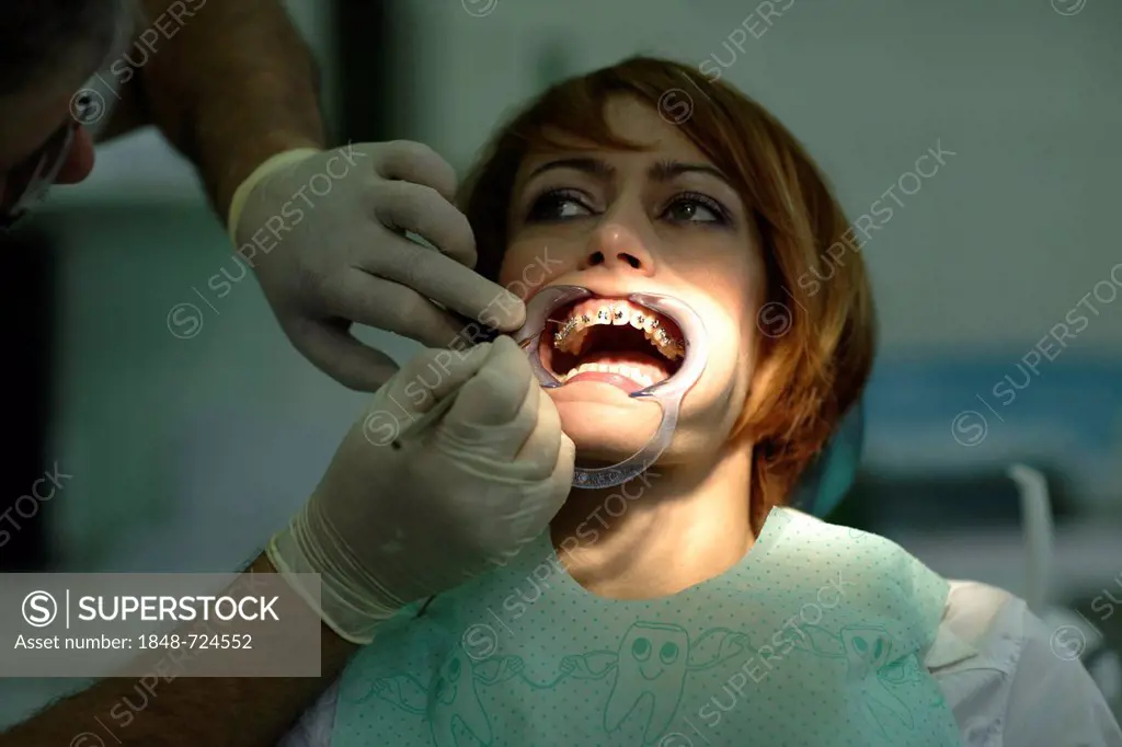 Patient is having a brace fitted at the dentist's