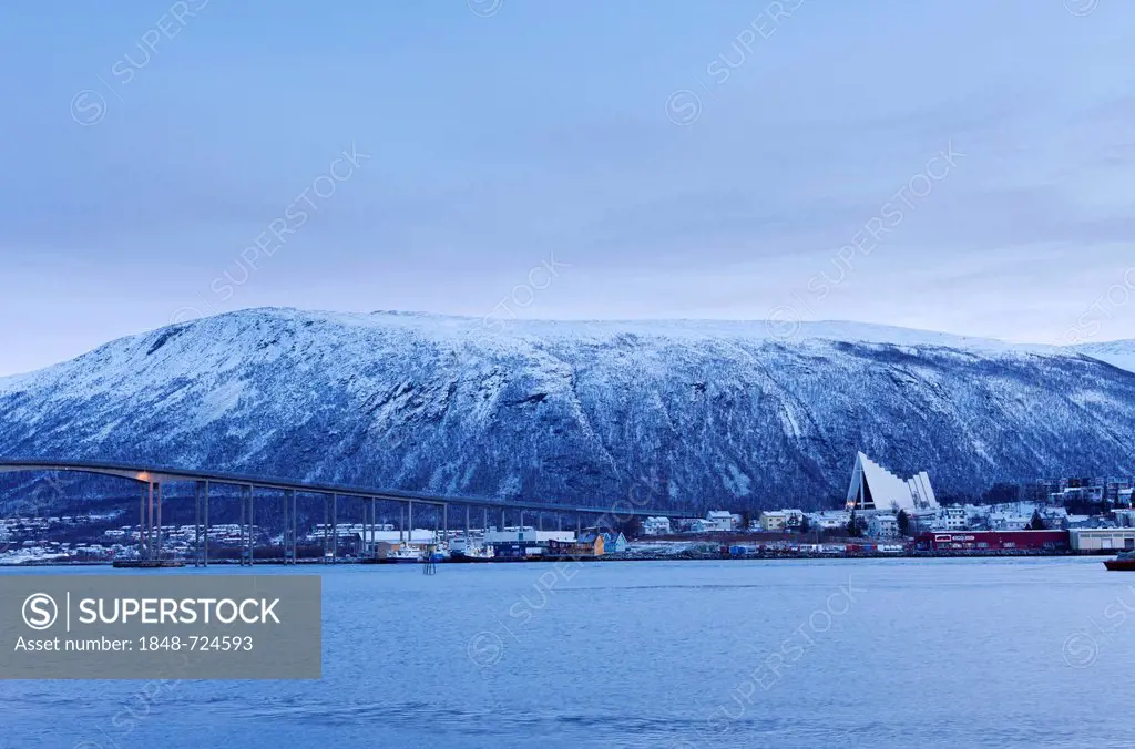Tromsdalen from the harbour area of Tromsø, Tromso, during the winter twilight, with Tromsdalen Church, Arctic Cathedral or Ishavskatredalen, and Trom...
