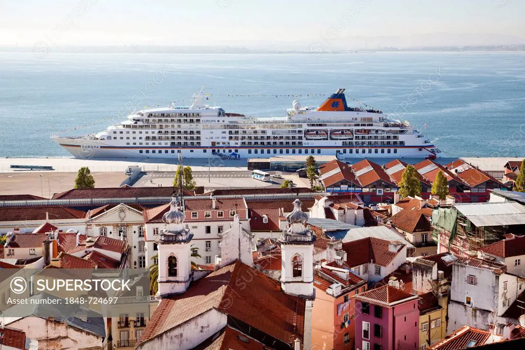View from the Miradouro da Santa Luzia lookout over the district of Alfama towards the Rio Tejo River, where the cruise ship MS Europa from the Hapag ...