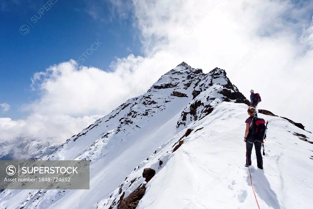 Hikers ascending the summit ridge to Hintere Eggenspitze Mountain in the Ulten Valley, Alto Adige, Italy, Europe