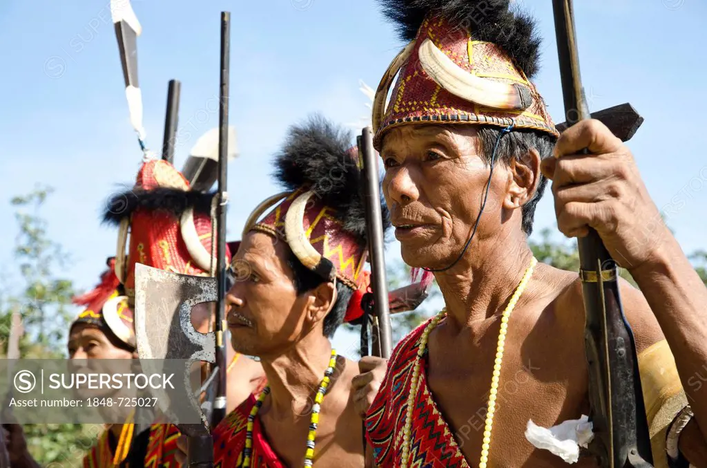 Warriors of the Phom tribe waiting to perform ritual dances at the Hornbill Festival, Kohima, Nagaland, India, Asia
