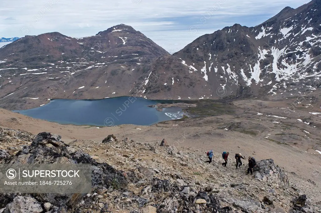Hikers at a lake near Tasiilaq or Ammassalik, East Greenland, Greenland