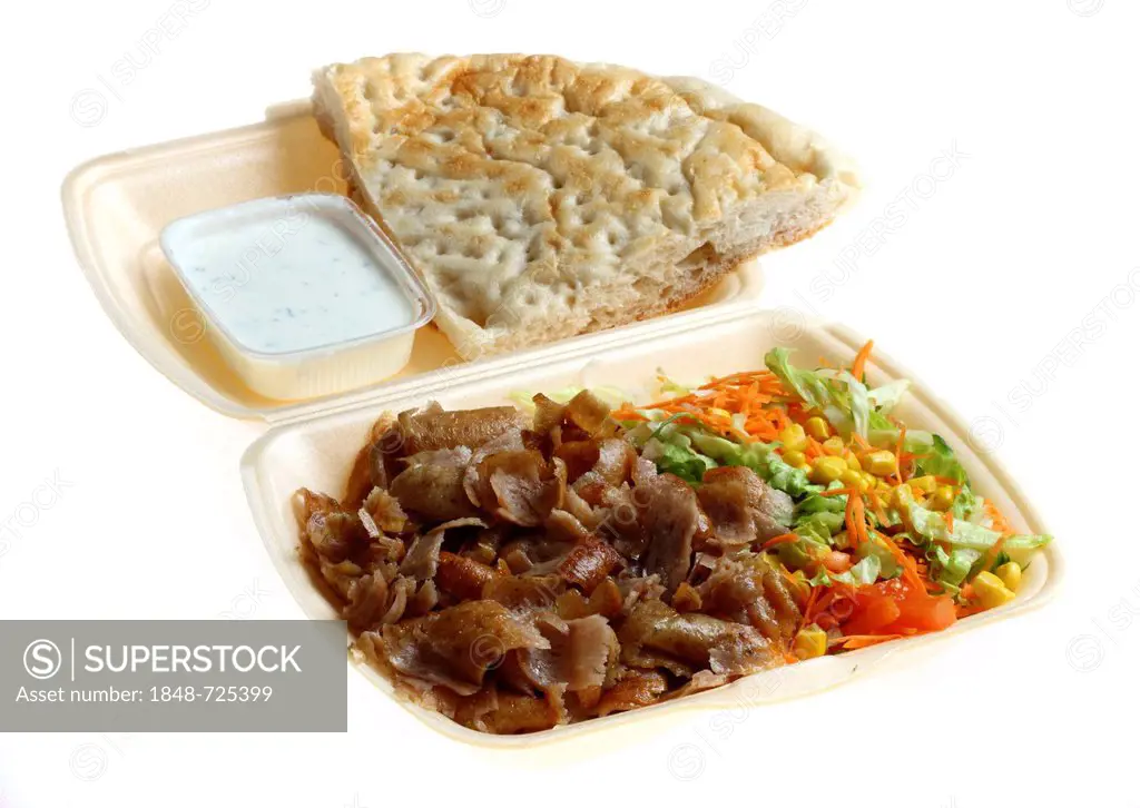 Fast food, doner kebab plate, with doner meat, salad, garlic-yogurt sauce and pita bread in plastic takeaway packaging