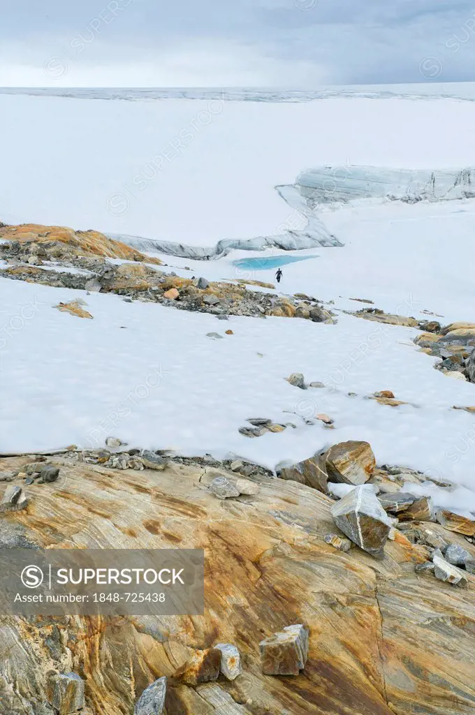 Coloured rock structures, hiker at Mittivakkat Glacier, Peninsula Ammassalik, East Greenland, Greenland