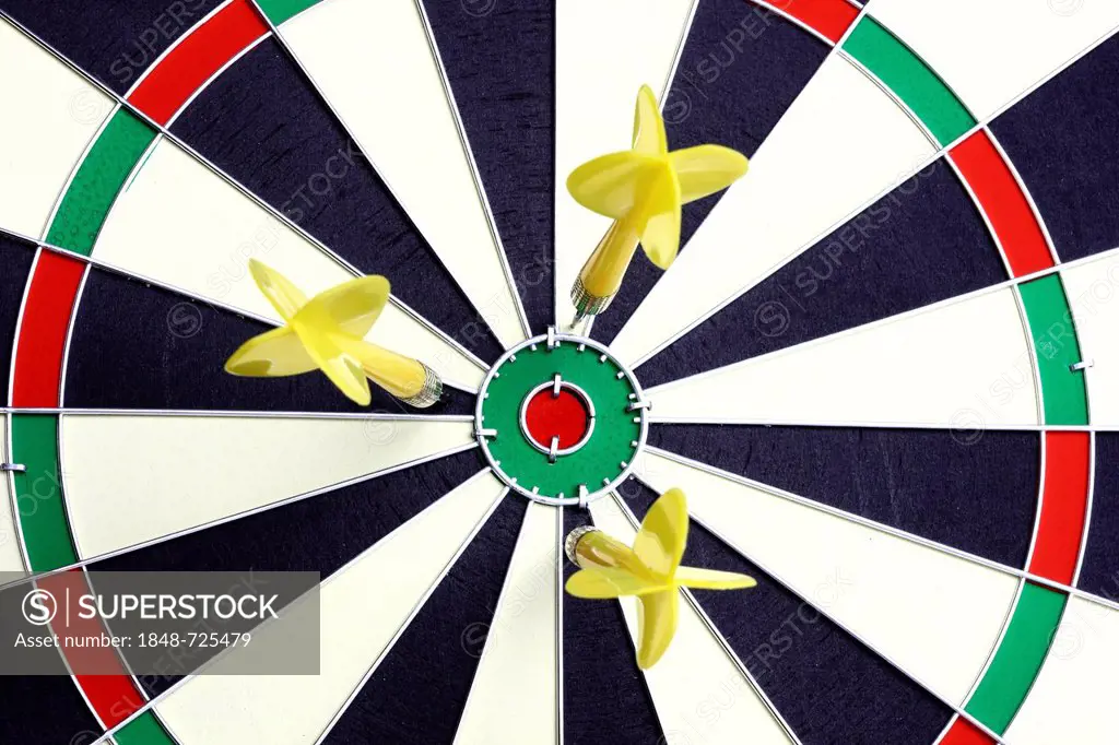 Darts, throwing game, darts narrowly off the middle of the dartboard, the bullseye