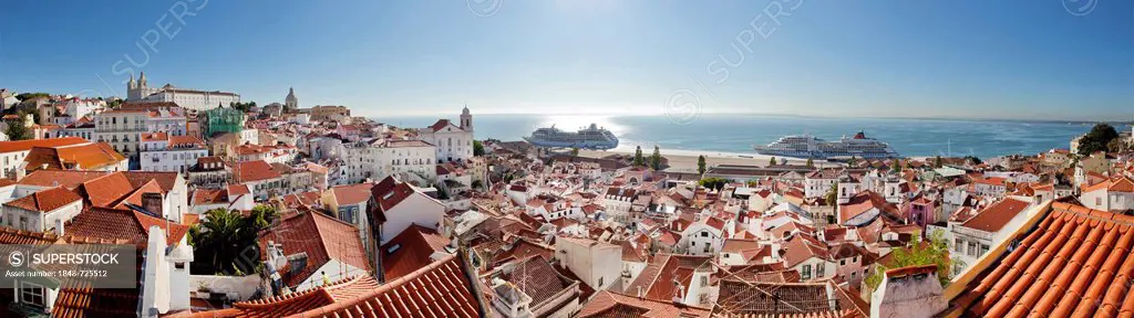 View from the Miradouro da Santa Luzia lookout over the district of Alfama towards the Rio Tejo River, where two cruise ships are moored, Lisbon, Port...