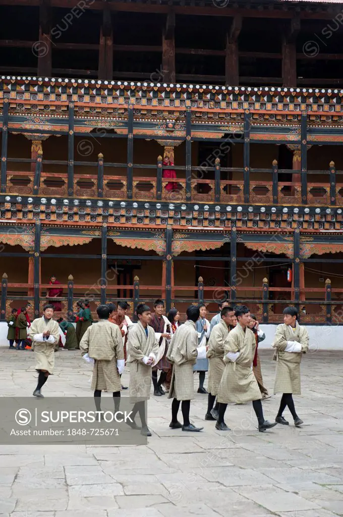 Tibetan Buddhist festival, men wearing the traditional Gho robe, Rinpung Dzong Monastery and Fortress, courtyard, Paro, Himalayas, Bhutan, South Asia,...
