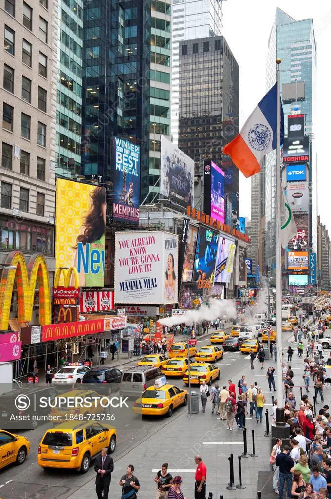 Metropolis, traffic, high-rise buildings and bright neon advertising signs, yellow cabs, taxis, intersection of Broadway and 7th Avenue, Times Square,...