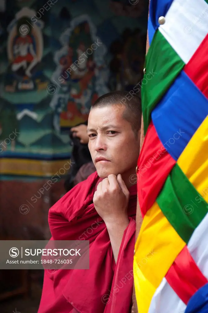 Tibetan Buddhism, monk wearing a red robe looking pensive, Rinpung Dzong Monastery and Fortress, Paro, Himalayas, Bhutan, South Asia, Asia