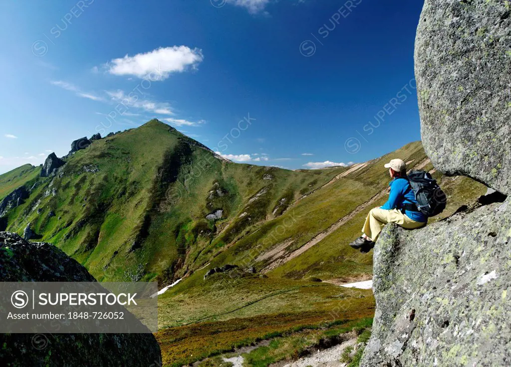 Hiker in the Massif du Sancy, Parc Naturel Regional des Volcans d'Auvergne, Regional Nature Park of the Volcanoes of Auvergne, Monts Dore, Puy de Dome...