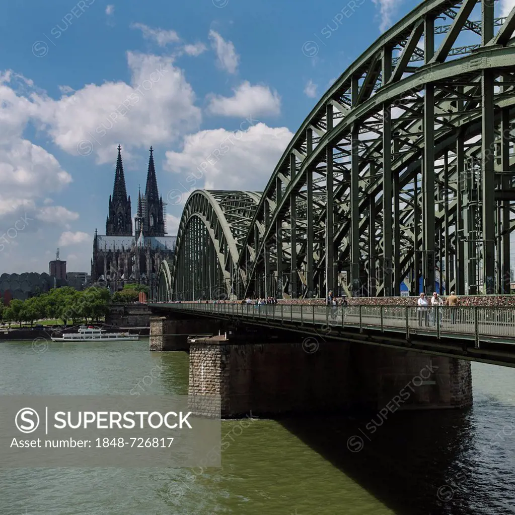 View across the Rhine River towards Cologne Cathedral and Hohenzollern Bridge, North Rhine-Westphalia, Germany, Europe