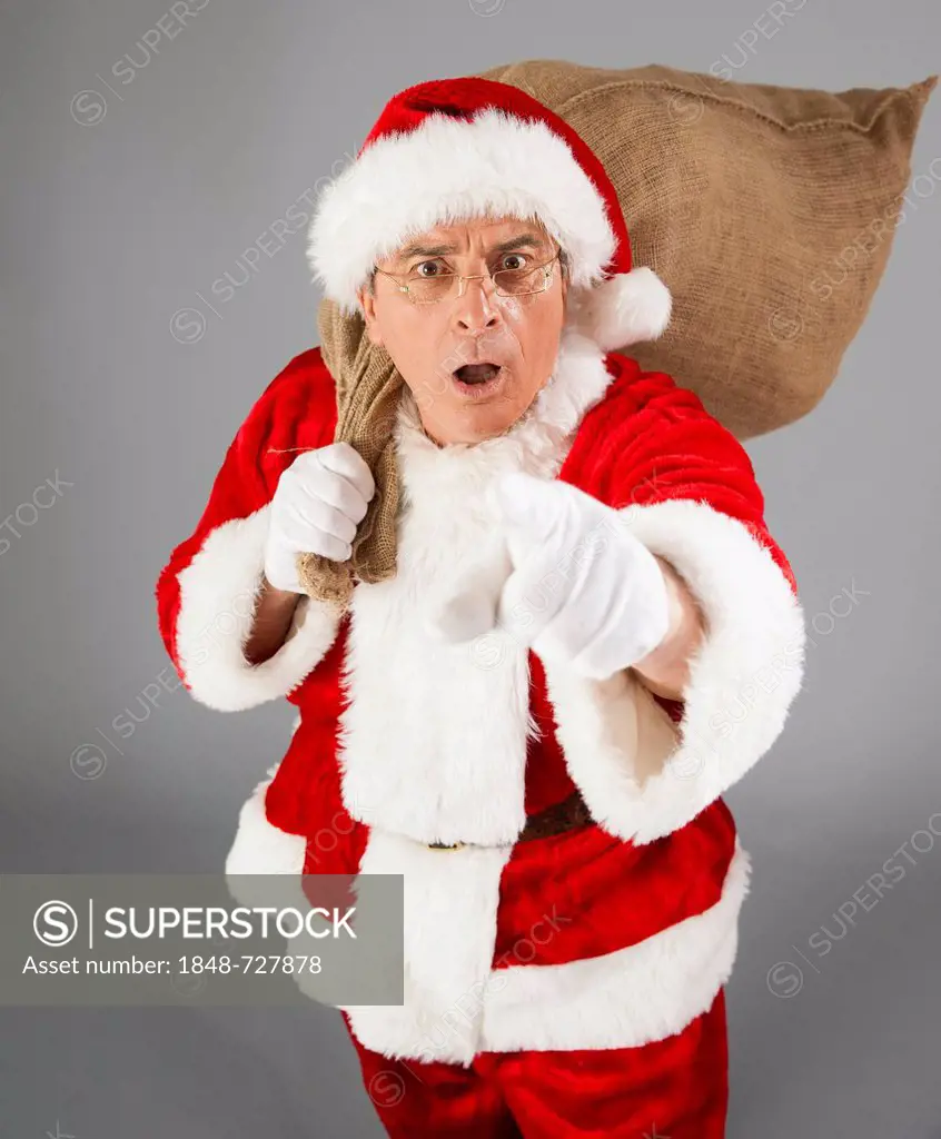 Surprised Santa Claus holding a sack