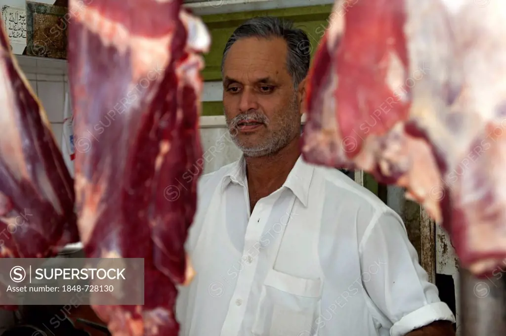 Butcher in his shop at the meat market in Sharjah, United Arab Emirates, Middle East