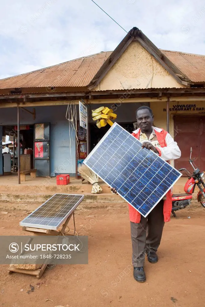 Mr. Tinkasimire, owner of an electrical shop, offering products like Premier Modul solar panels, Masindi, Uganda, Africa