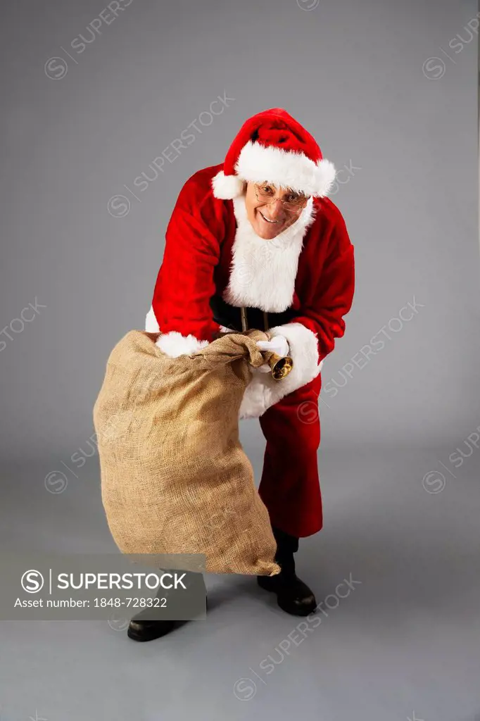 Santa rummages in a bag