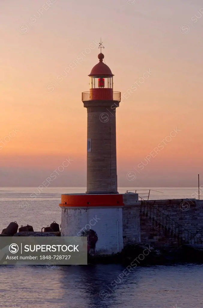 A lighthouse at the entrance of the harbor of Bastia at sunrise, Saint Joseph, Bastia, Corse, Corsica, France, Europe