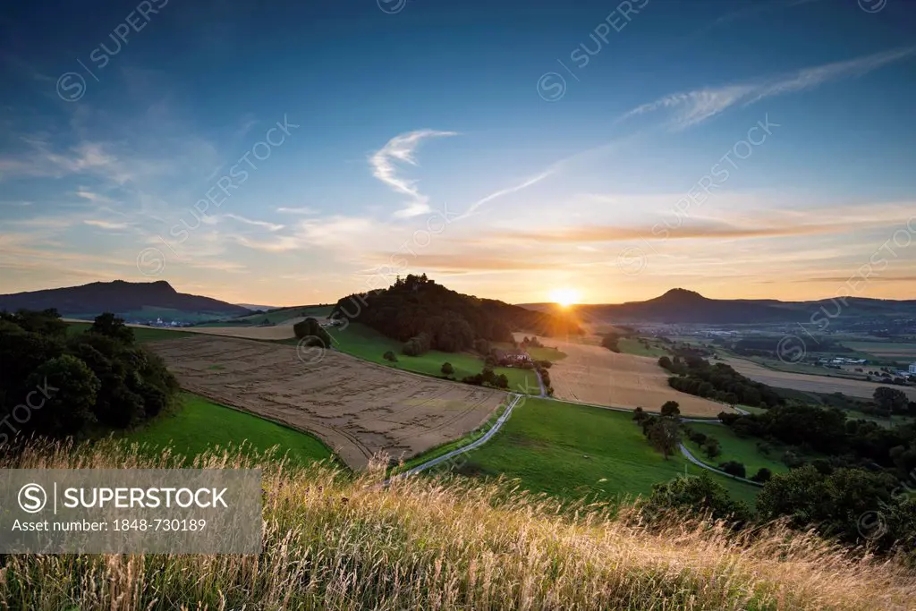 Sunset over the Hegau volcanoes Hohenstoffeln, on the left, Maegdeberg, in the middle, and Hohenhewen, on the right, Baden-Wuerttemberg, Germany, Euro...