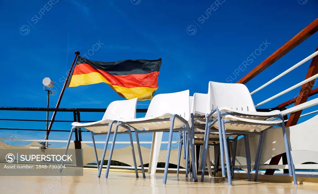 German flag flying behind empty rows of chairs on the rear of an excursion boat, Berlin, Germany, Europe