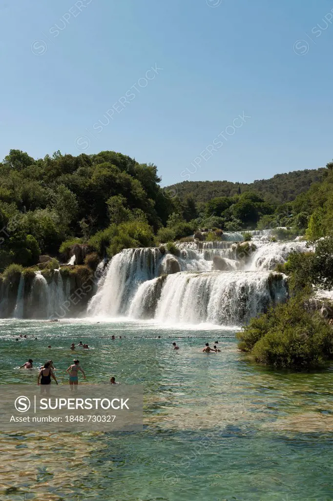Bathers below a waterfall, Krka National Park, Croatia, Southern Europe, Europe