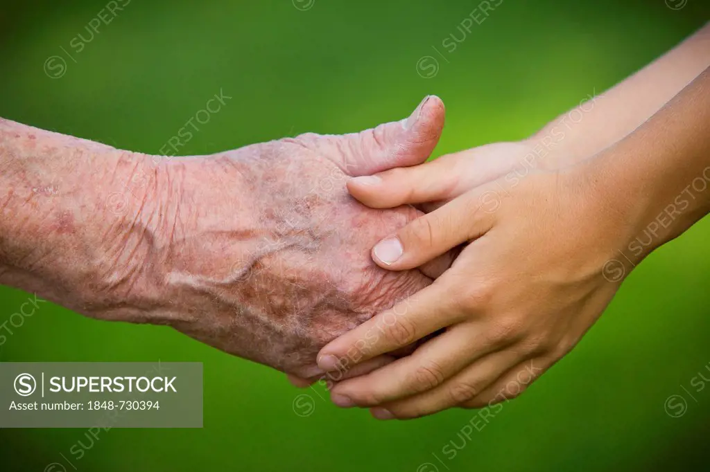 Elderly woman and a child holding hands