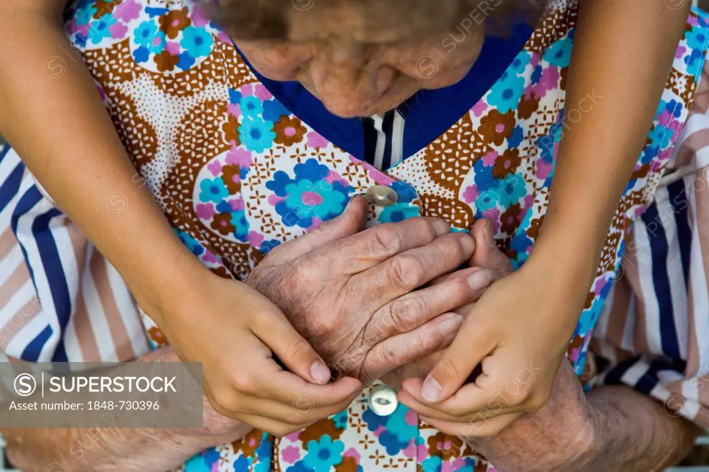 Child hugging an elderly woman