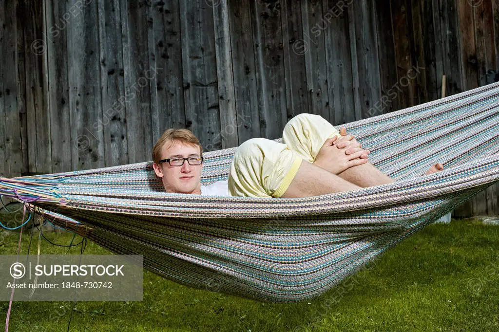 Teenager lying in a hammock