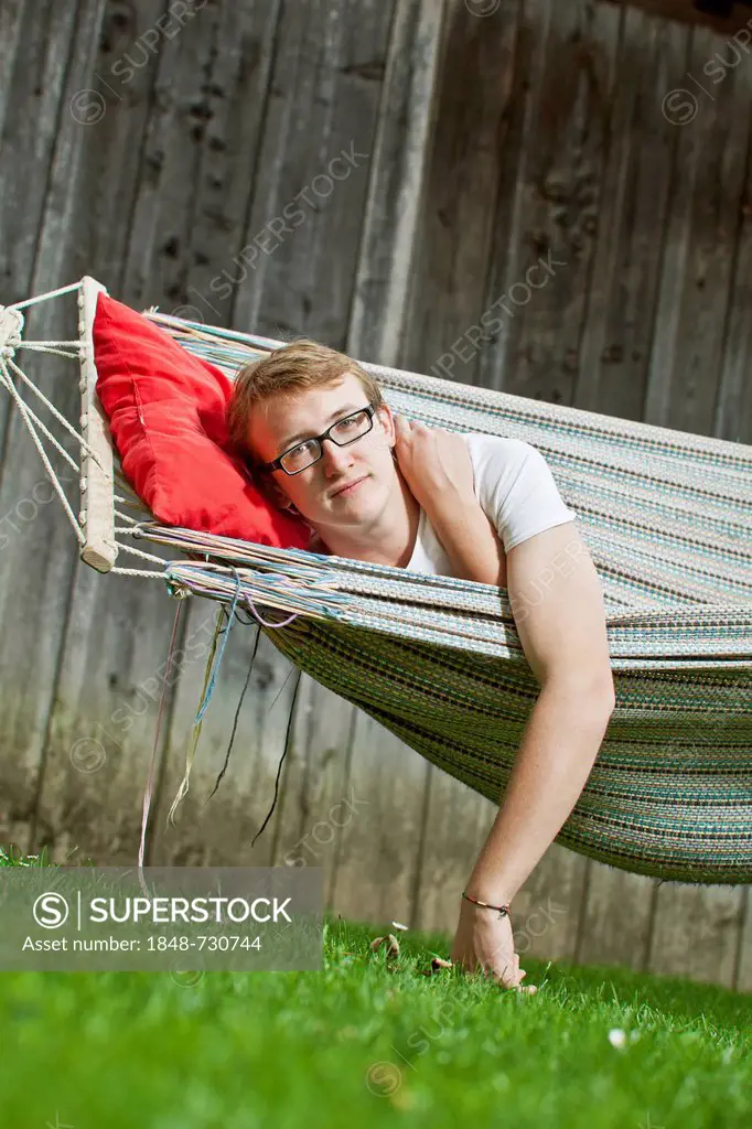 Teenager lying in a hammock