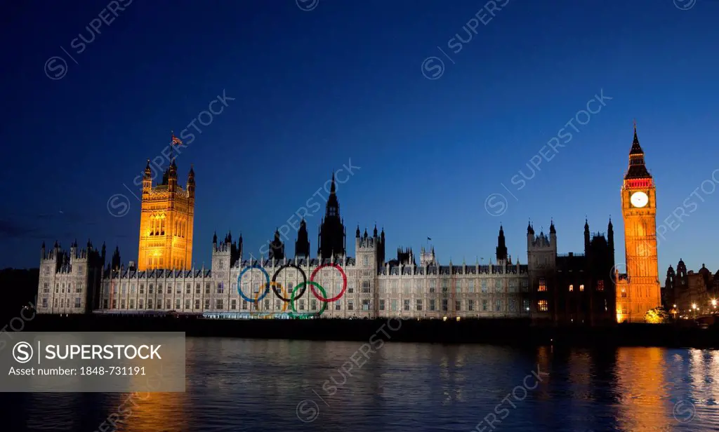 A giant image displaying the Olympic Rings is projected onto the facade of the Houses of Parliament for the Olympic and Paralympic Games 2012, London,...